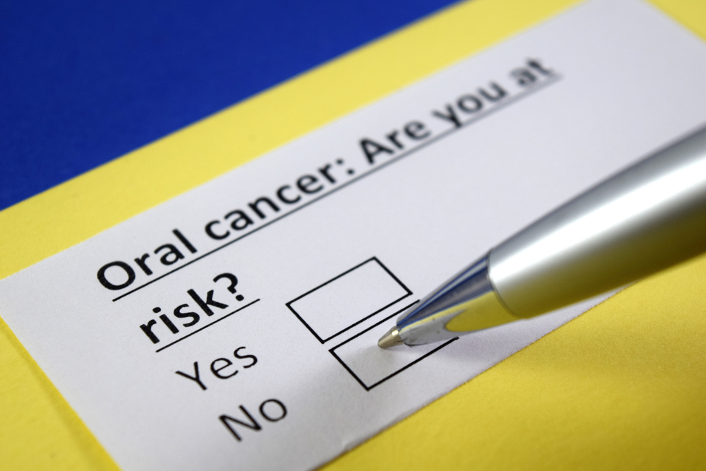 Blue, yellow and white document asking if you are at risk for oral cancer with yes and no checkboxes
