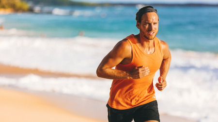 Man running on the beach sweating